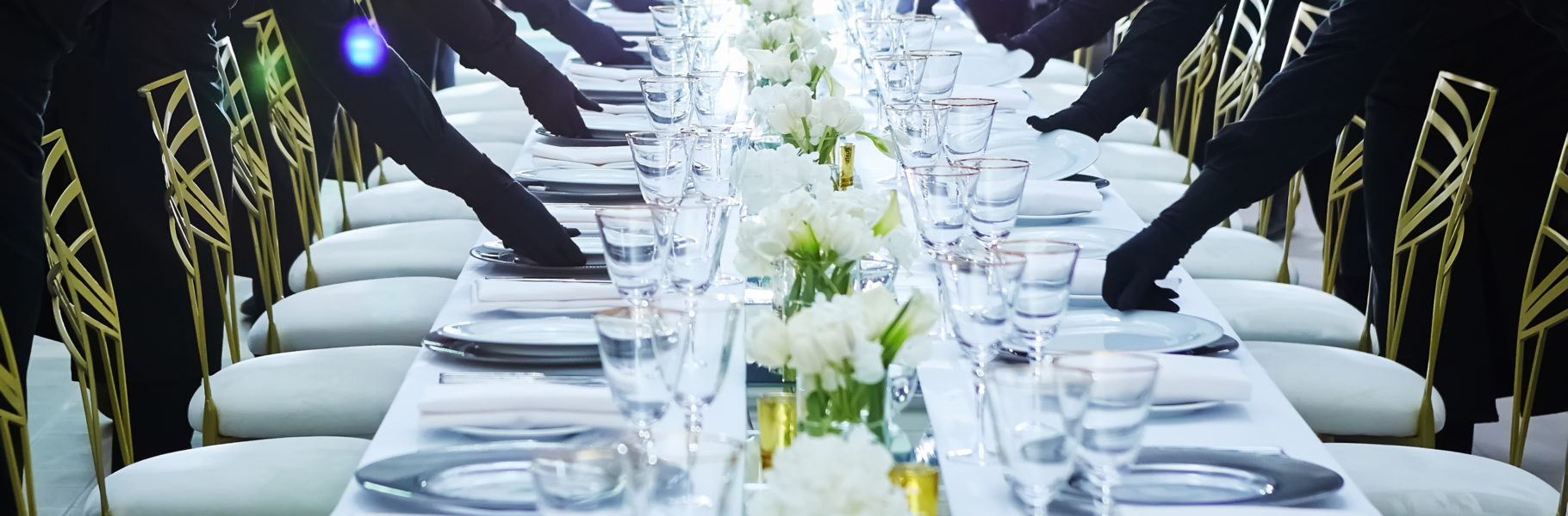 Large group of waiters serving a banquet